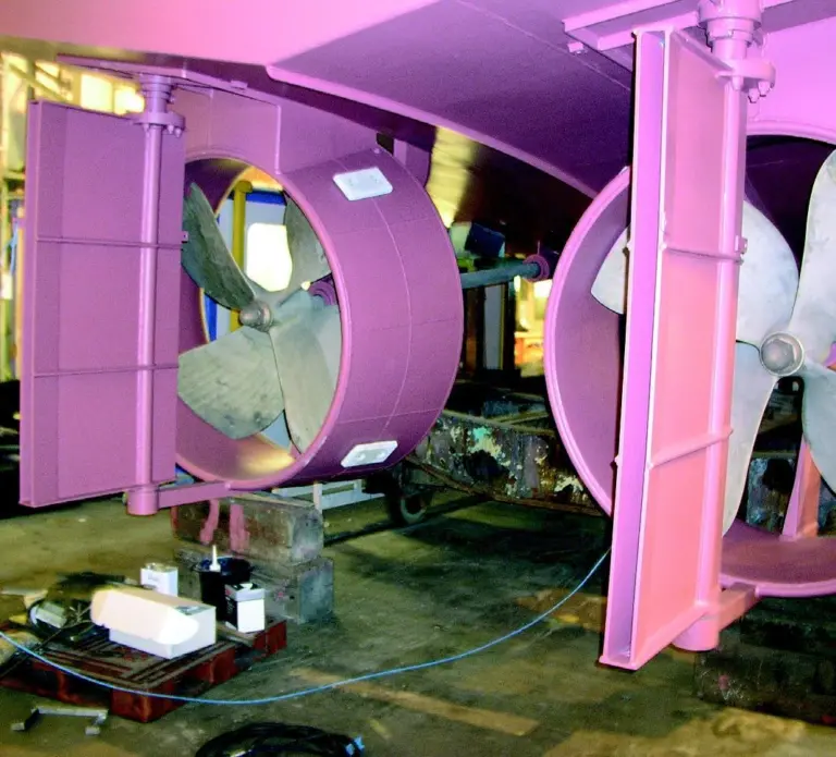 A twin-screw propulsion system includes fixed Kort nozzles and fish-tail rudders.