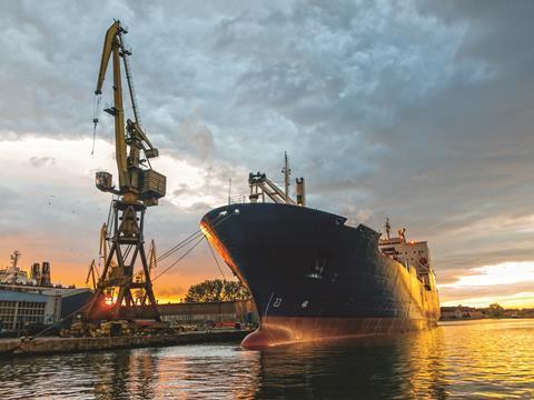 IM&M promo image of a ship docked at a container port