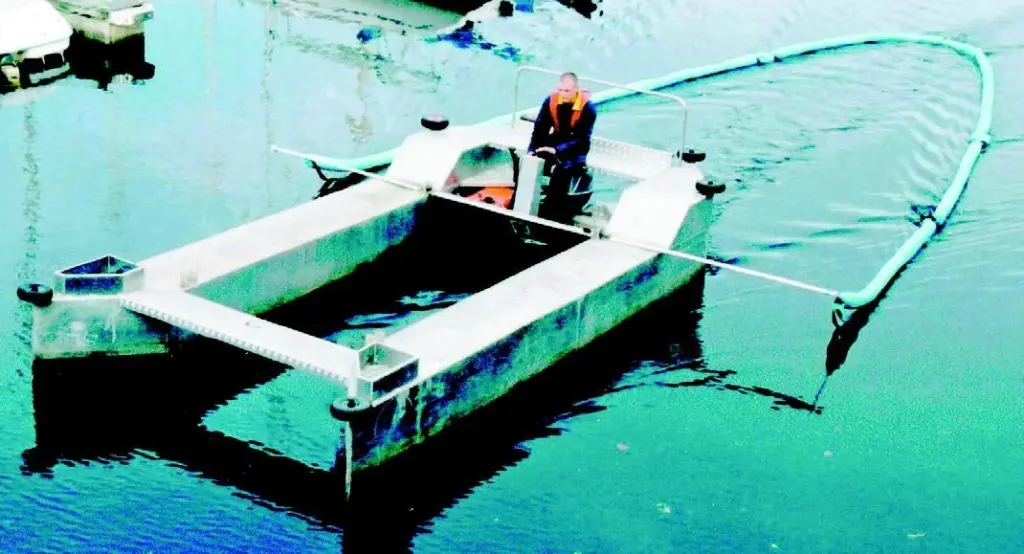Swansea Marinas Skipa trails an oilboom through crowded waters gathering spilled diesel.