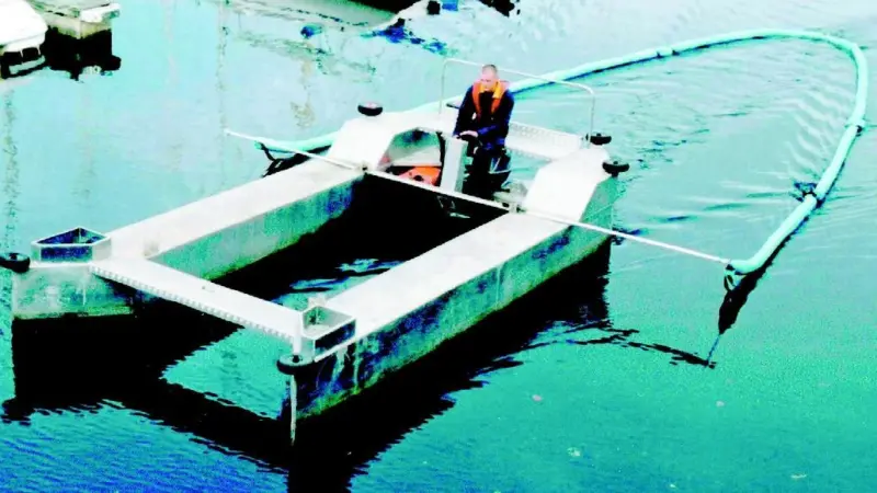 Swansea Marinas Skipa trails an oilboom through crowded waters gathering spilled diesel.