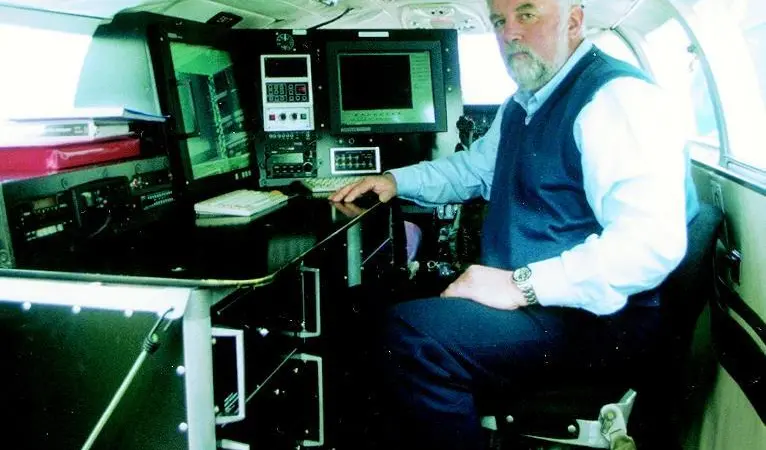 Atlantic Reconnaissance Technical Director Roger Stockham at the surveillance console he designed for the MCA.