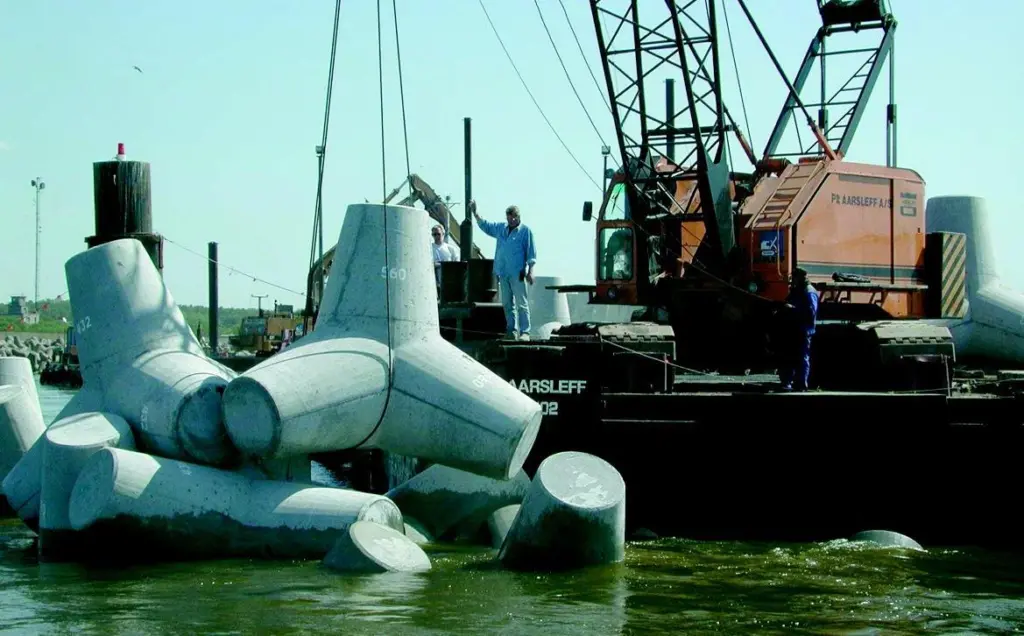 Tetrapods are lowered into place by one of Per Aarsleffs cranes.
