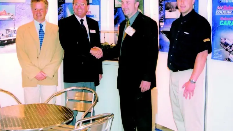 In a signing ceremony at seawork2002, Halmatics Ian Strugnell and D. Ferran and Sons Justin Ferran (left and right centre) are flanked by Tony Ward of Volvo Penta and Andrew Stammers of Jotun.