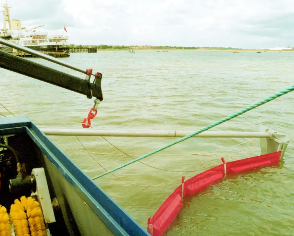 The Heila crane retrieving the oil skimming boom and support jib. Note also the Lori brush pack.