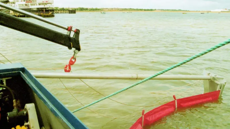 The Heila crane retrieving the oil skimming boom and support jib. Note also the Lori brush pack.