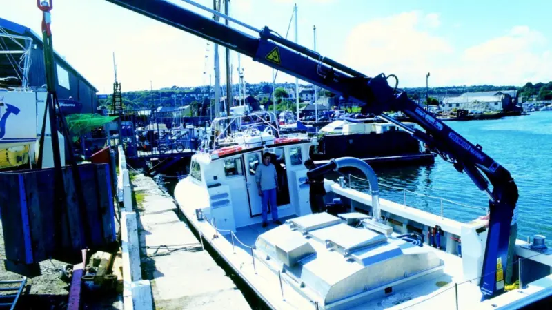 The Shanmharis Palfinger hydraulic crane makes easy work of heavy salmon feed containers.