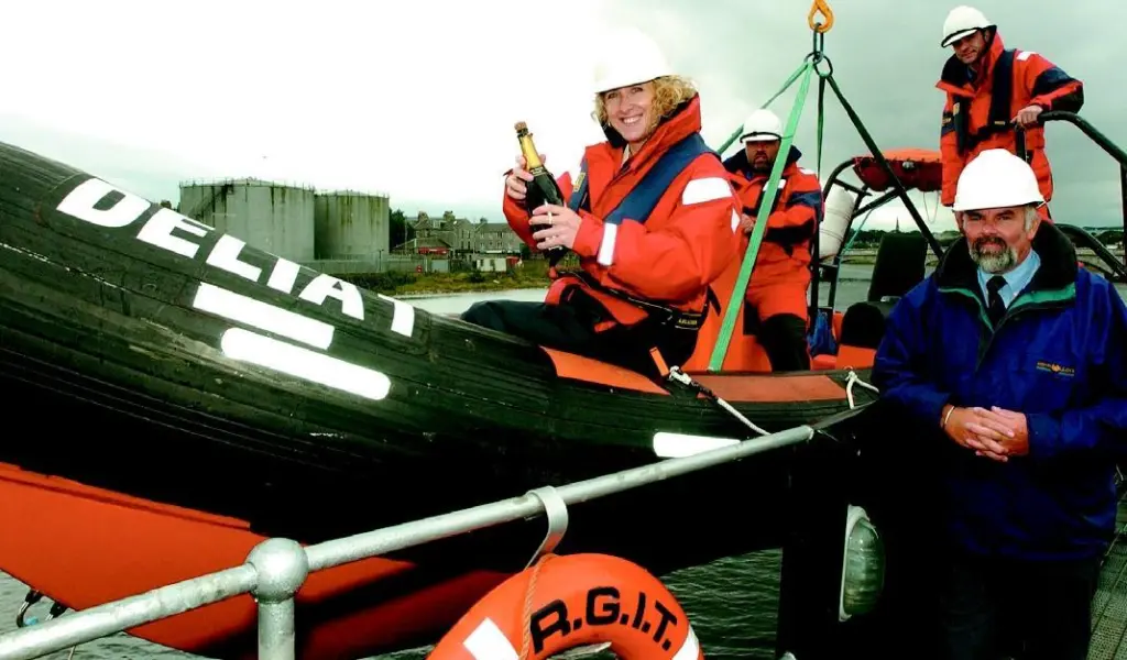 Dave Macmillan, Lesley Davidson, George Masson and George McGhie of RGIT Montrose toast the new fast rescue craft as it prepares to make its maiden voyage.