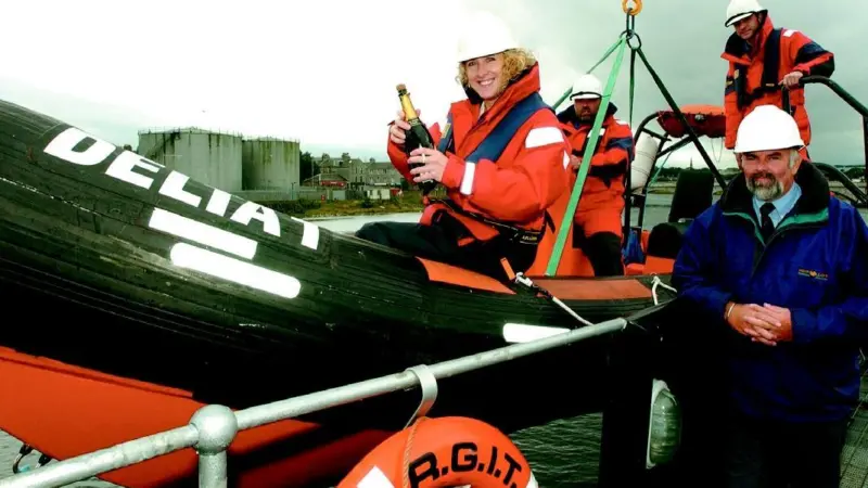 Dave Macmillan, Lesley Davidson, George Masson and George McGhie of RGIT Montrose toast the new fast rescue craft as it prepares to make its maiden voyage.