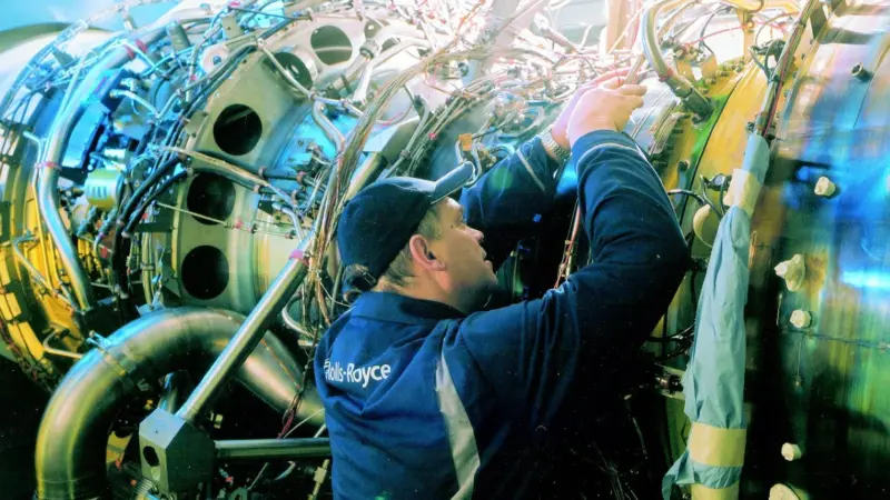 A Rolls Royce technician at work on the Bristol UK test engine.