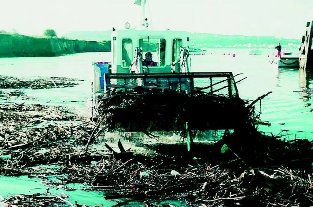One of the 69 earlier Water Witches is seen removing debris from Cardiff Bay UK.