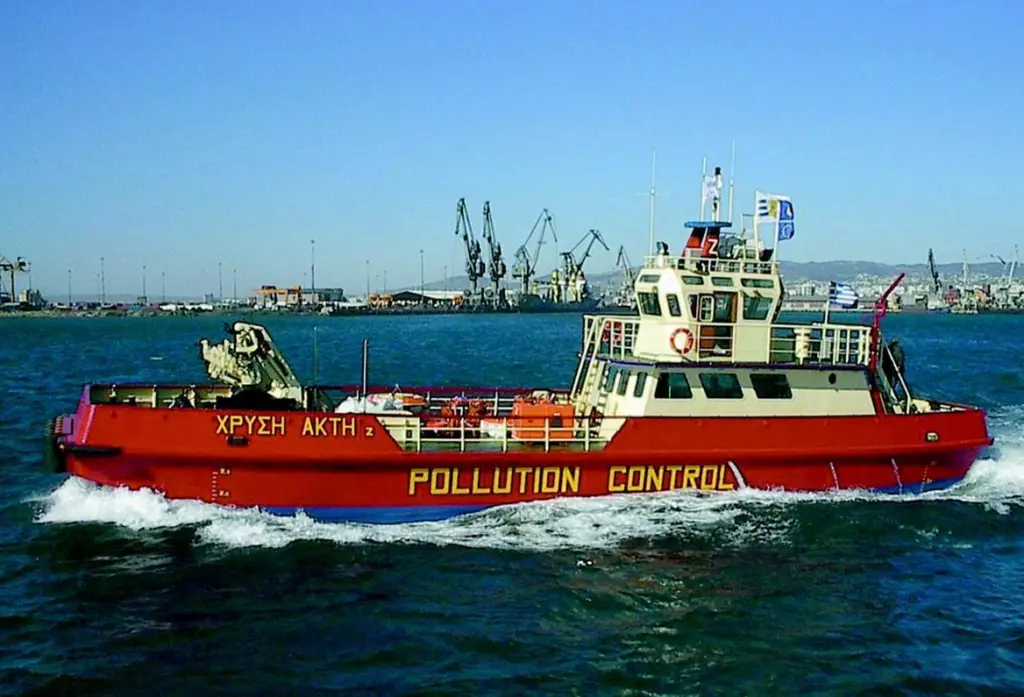 The Chrissi Akti Zs onboard crane can lift recovered oil from a storage barge.