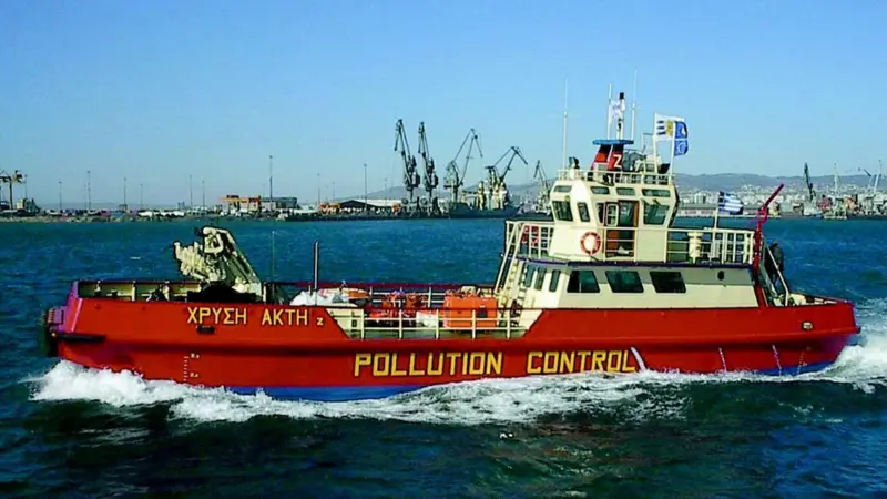 The Chrissi Akti Zs onboard crane can lift recovered oil from a storage barge.