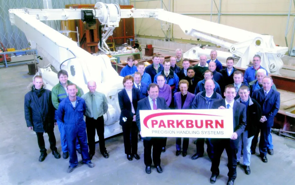 P-PHS employees display the new corporate livery in front of an A-Frame shipborne launch and recovery system awaiting delivery.