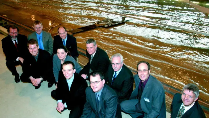 Smile and wave. Interested parties recently visiting ABPmer are seen before the wave basin model of Blackpools seafront.