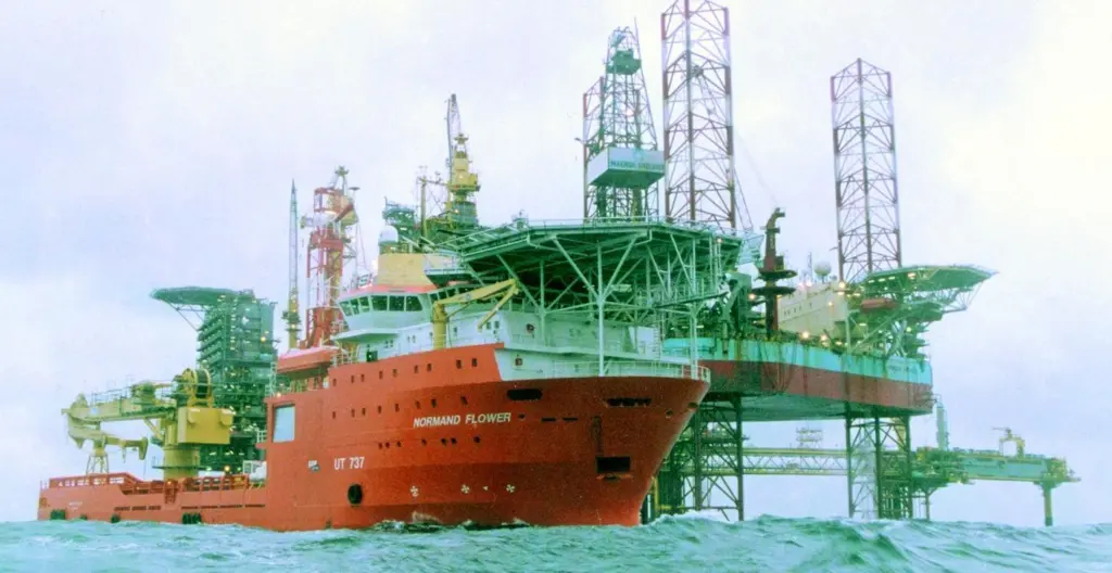 Seacores C100 heave compensated drill at work on board DP3 class vessel Normand Flower as the craft holds station only 40m from an offshore platform.