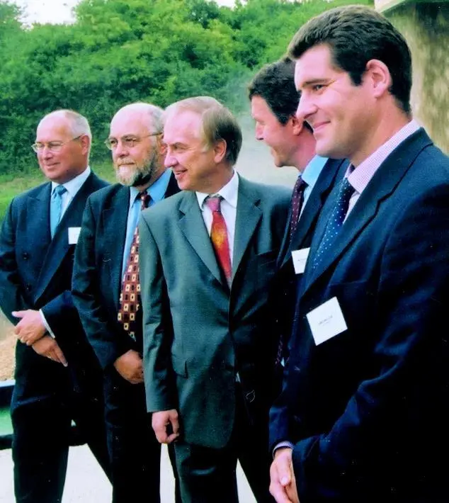 Transport Minister David Jamieson MP (centre) moments after starting the conveyor delivery to the barge.