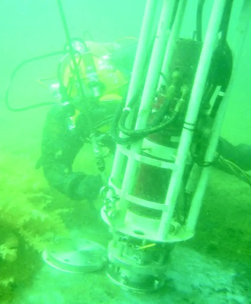 A diver is seen hot tapping for oil on the hull of the Royal Oak.