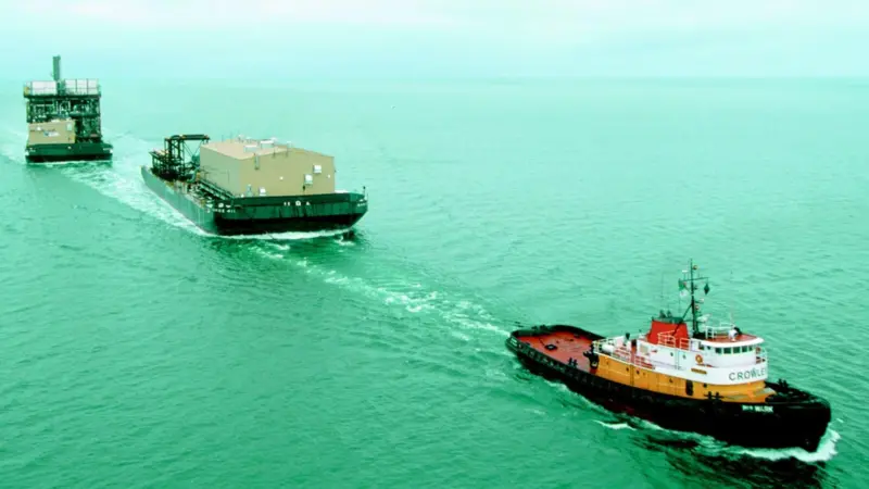The Crowley tug Bulwark is seen underway with a tandem tow - typical employment for an Invader class vessel.