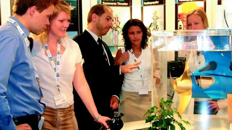 Schottels director of marketing and sales, Christophe Mourout (centre), demonstrates the advantages of the Schottel Electric Propulsor (SEP) by means of a working model.