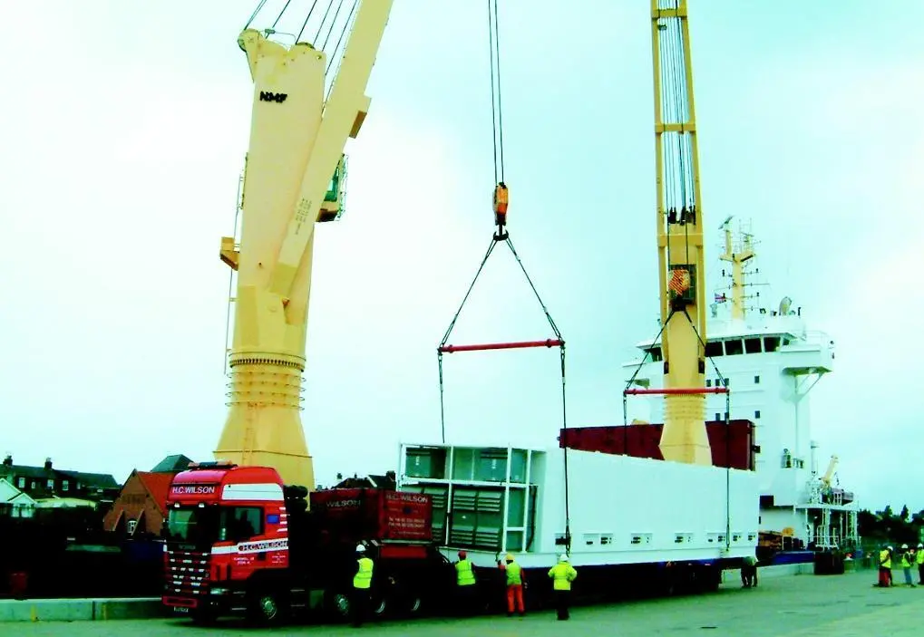The valuable cargo is transferred from ship to road transport using a Modular Lifting Beam.
