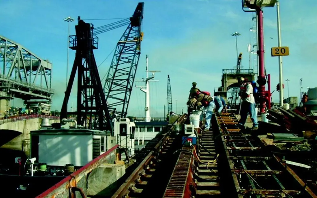 Installing new sections of prefabricated tow track along the tops of the locks.