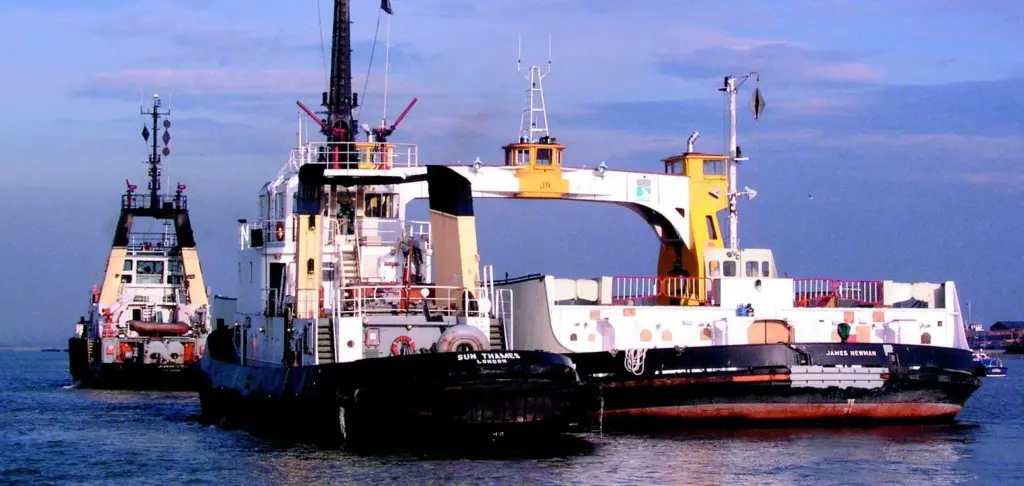 Tugs from Adsteam tow away the fire damaged James Newman .