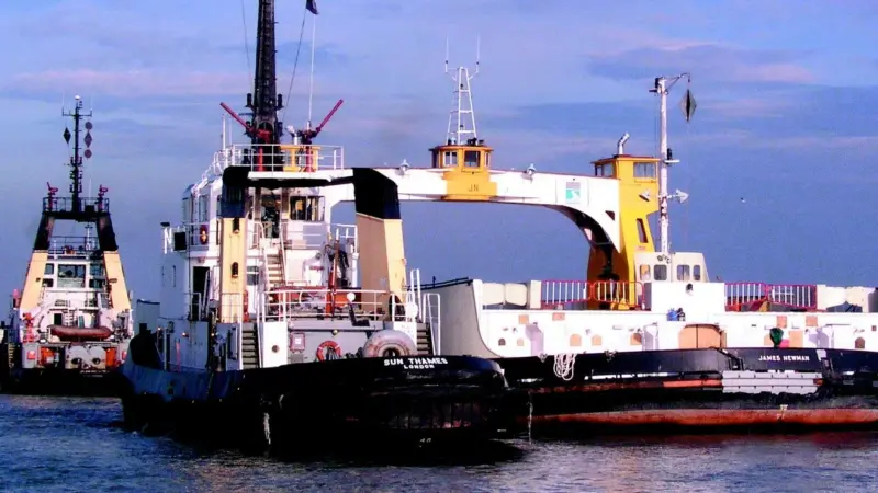 Tugs from Adsteam tow away the fire damaged James Newman .