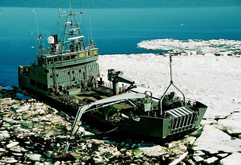The Finnish vessel Hylje is seen using a Lamor bucket skimmer to collect oil in icy waters.