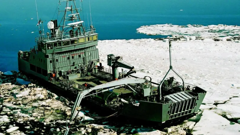 The Finnish vessel Hylje is seen using a Lamor bucket skimmer to collect oil in icy waters.