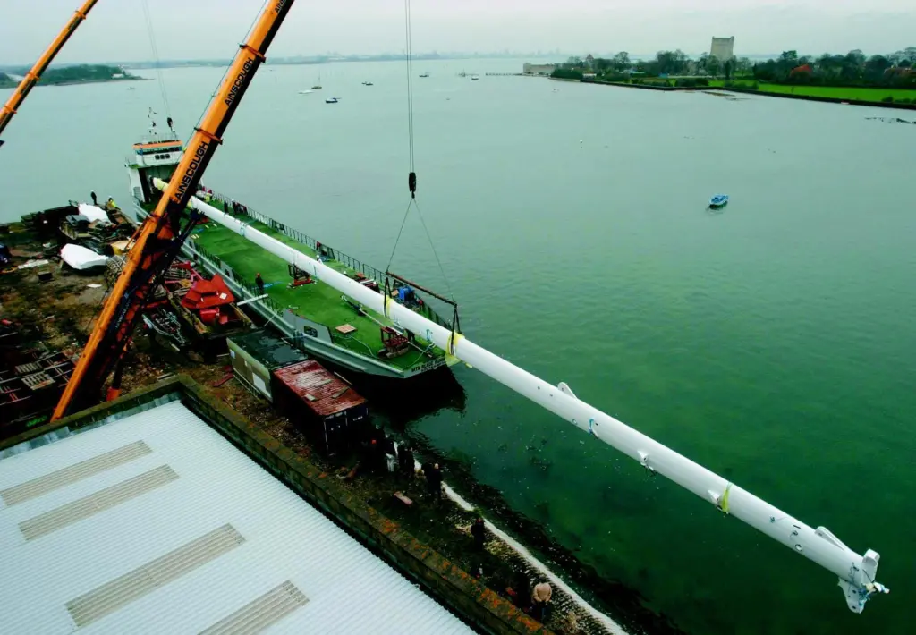 The Mirabella V mast is loaded onto a barge at VT Halmatics Portchester shipyard.