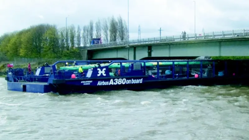 Holyhead Towings Afon Dyfrdwy, with the first Airbus wing onboard, passes under the A494 dual carriageway bridge at Queensferry on the ebb tide, allowing 500mm of clearance between bridge and vessel.
