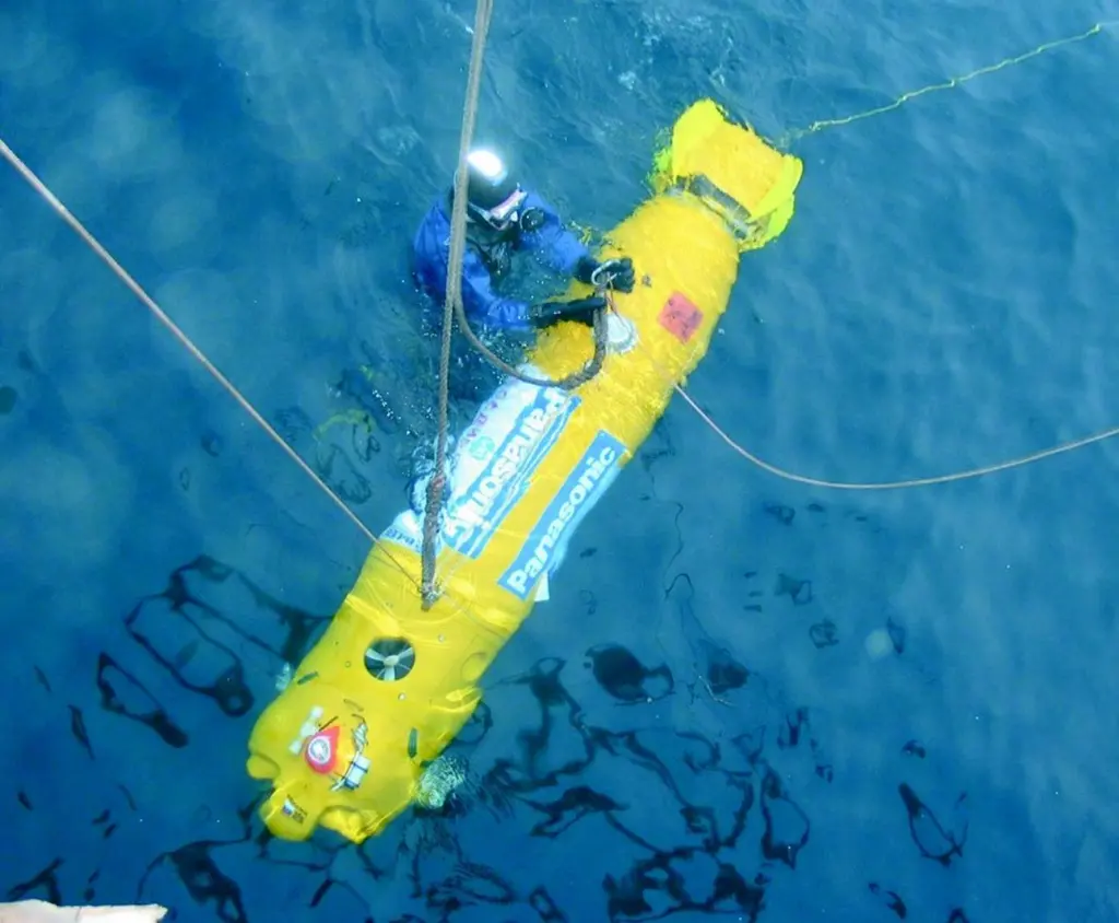 An Expedition diver working with the tele-controlled robot.