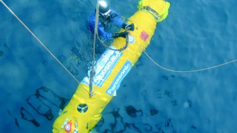 An Expedition diver working with the tele-controlled robot.