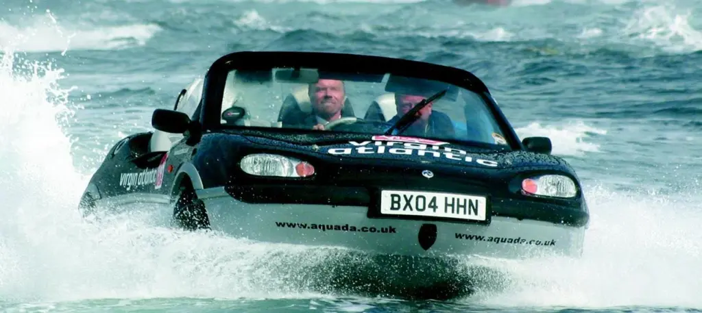Richard Branson knocks six hours off the record for crossing the English Channel in a car boat.
