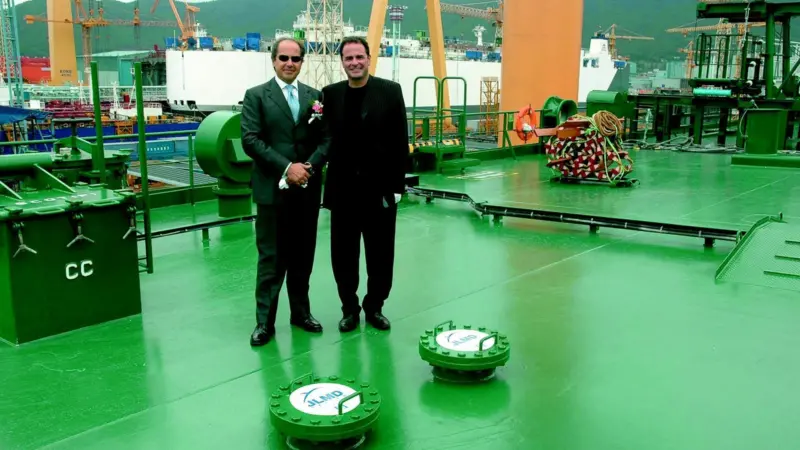 Fabio Montanari, CEO of Navigazione Montanari and Jean-Luc Dabi, CEO of the JLMD Ecologic Group and inventor of the JLMD system, are seen on board Montanaris new ship Valtamed with system caps in the foreground.