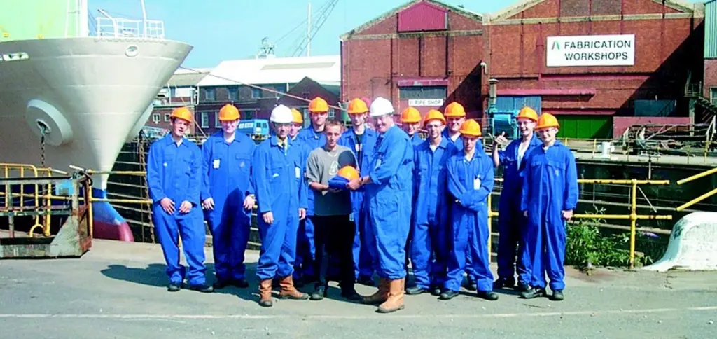 A&P Falmouths managing director Peter Child presents the new apprentices with their personal protective equipment, assisted by training and personnel officer Paul Kneebone.