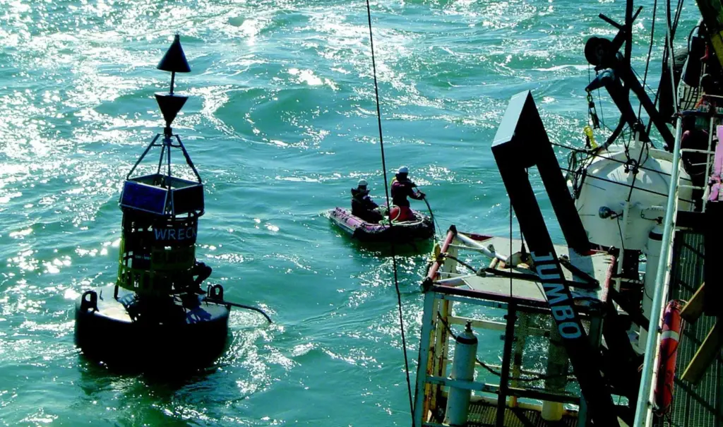 A monitoring team alongside the dredger Prins der Nederlanden check for movement of the wreck on the seabed below.