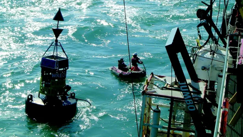 A monitoring team alongside the dredger Prins der Nederlanden check for movement of the wreck on the seabed below.
