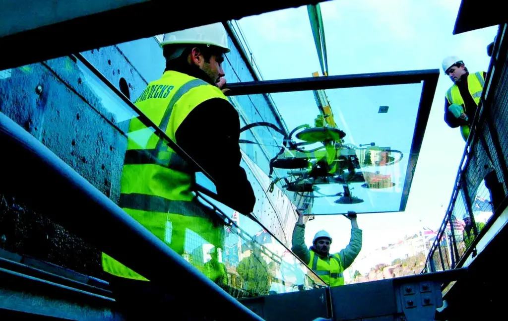 One of 170 glass panels which will protect the hull of ss Great Britain from further corrosion is lowered into position.