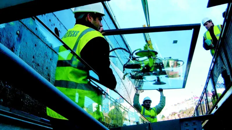One of 170 glass panels which will protect the hull of ss Great Britain from further corrosion is lowered into position.