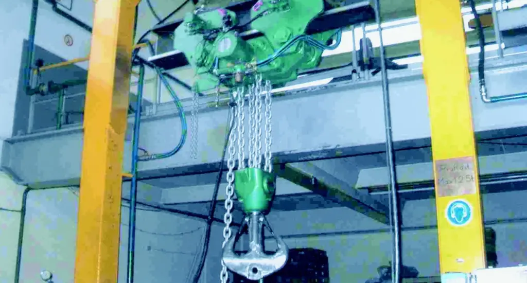 Ram hook with shackle bore lifting attachment during production tests when fitted to EH 50 pneumatically operated monorail hoist, supplied by J D Neuhaus for use at an American shipyard.
