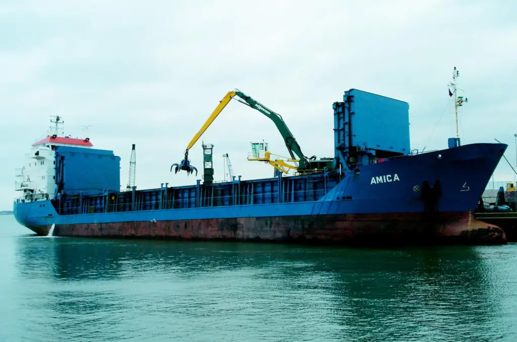 The first Sennebogen 870R material handler in a UK port is seen at work unloading scrap in Poole Harbour.
