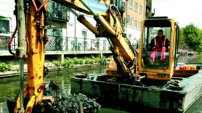 Land & Waters work includes dredging bridge holes and problem areas to accommodate freight barges.