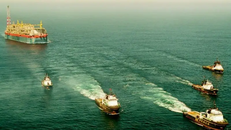The Kizomba B is seen under tow and escort by five tugs as it approaches the Angolan coast last month.