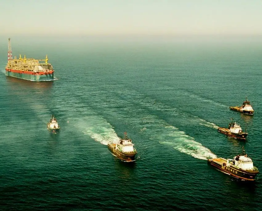 The Kizomba B is seen under tow and escort by five tugs as it approaches the Angolan coast last month.