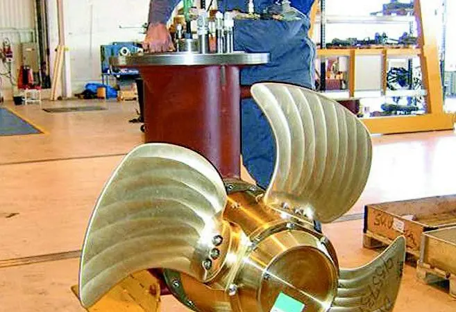 A Rolls-Royce technician overhauls a thruster under optimal workshop conditions.