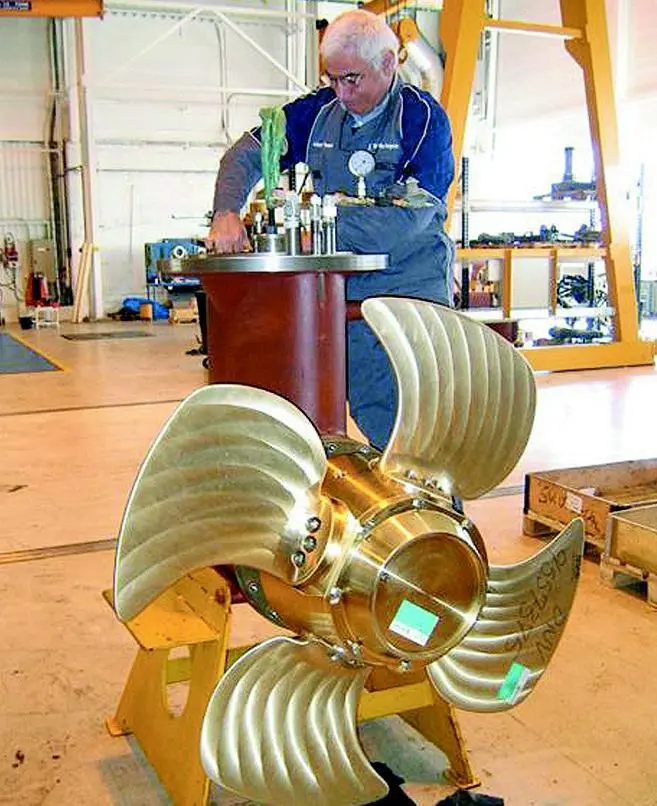 A Rolls-Royce technician overhauls a thruster under optimal workshop conditions.