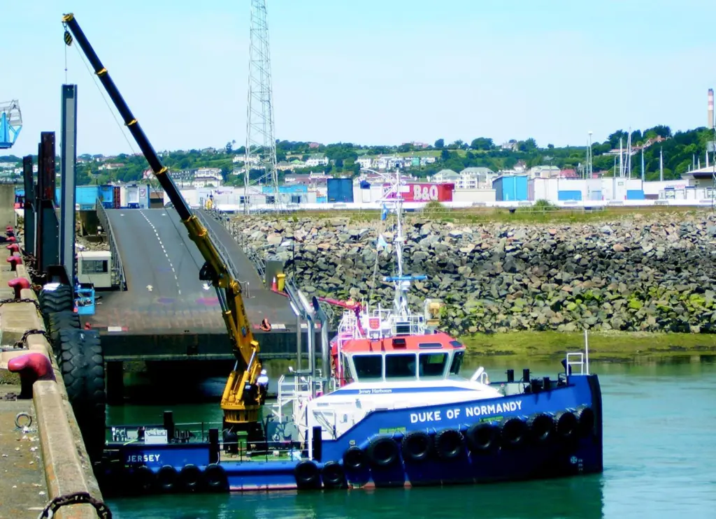 Very large tides in Jersey harbour make a long reach crane invaluable.