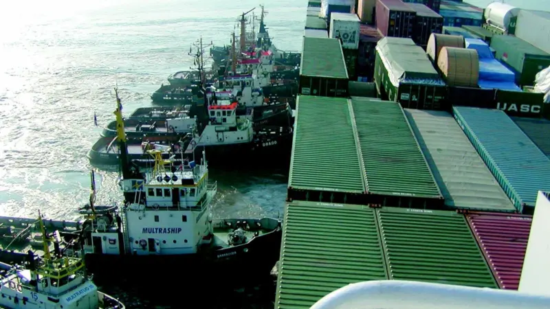 Multraship tugs are seen pushing the damaged containership Fowairet earlier this month.