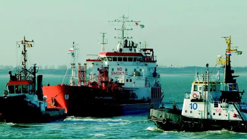 Multraship tugs pull the Philipp Essberger free in the River Scheldt. Photo by Lex de Meester.